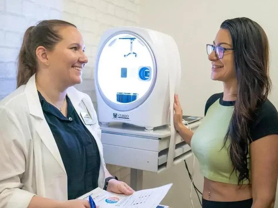 Smiling aesthetician giving customer advice